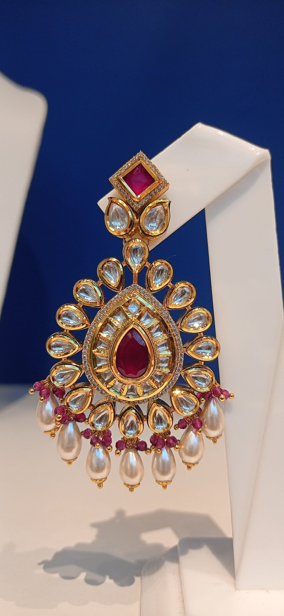 Simina Imitation Ruby and Polki Diamond Kundan Necklace, Earrings and Teeka Bridal Jewellery Set