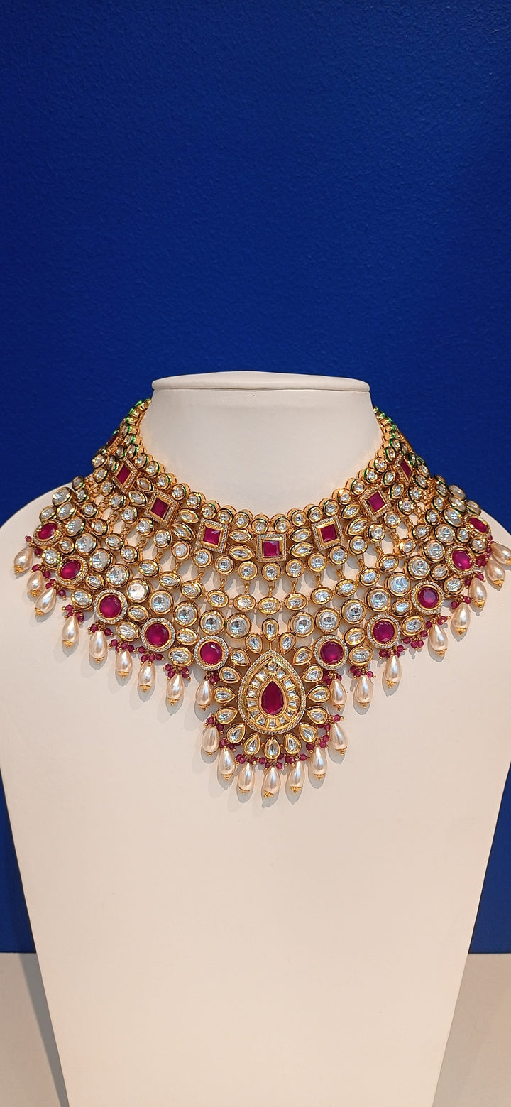 Simina Imitation Ruby and Polki Diamond Kundan Necklace, Earrings and Teeka Bridal Jewellery Set